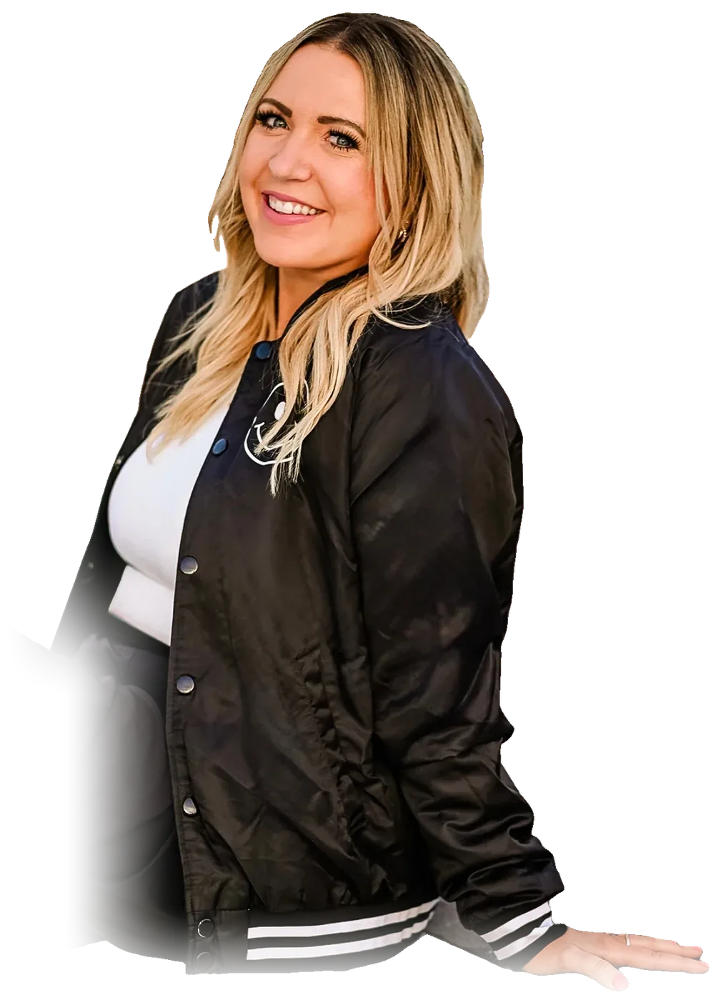 Dani, founder of the Bestie Squad, smiling in a black Bestie bomber jacket.