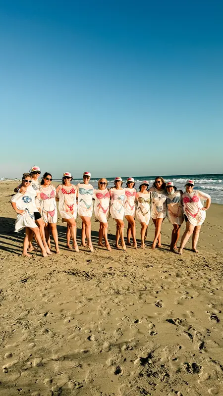 Bestie Squad members in matching tees lined up together on the beach.